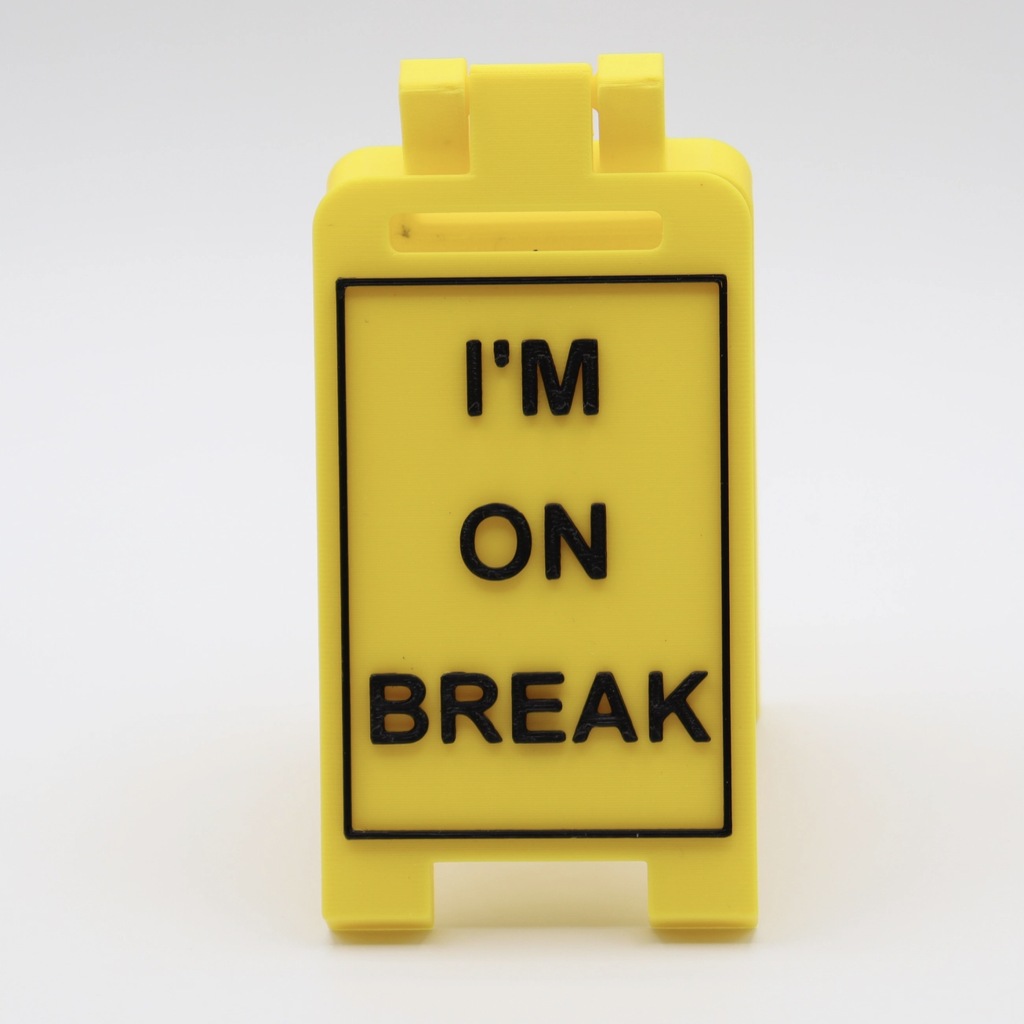 'I'm On Break' yellow fold-out desk sign with raised black lettering